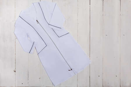 Nurse uniform on white table, modern medical fashionの写真素材