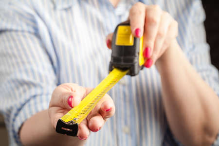Penis Size Concept. Woman with Measuring Tapeの写真素材