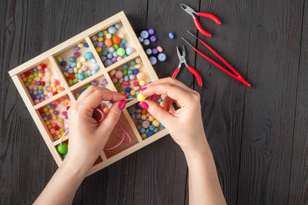 Woman making jewelry at homeの写真素材