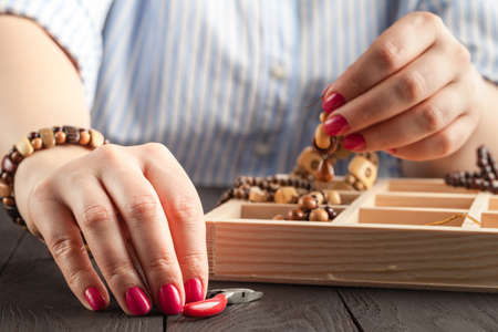 beautiful women at the table making jewelryの写真素材