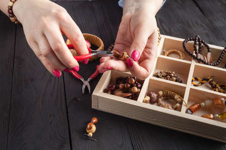 Woman making jewelry at homeの写真素材