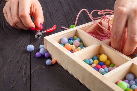 Jewelry making and beading process.Colored beads.Beaded jewelryの写真素材