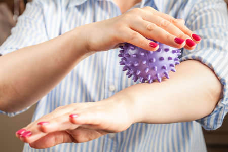 Woman with occupational therapy, peeling or massage with hedgehog ballの写真素材
