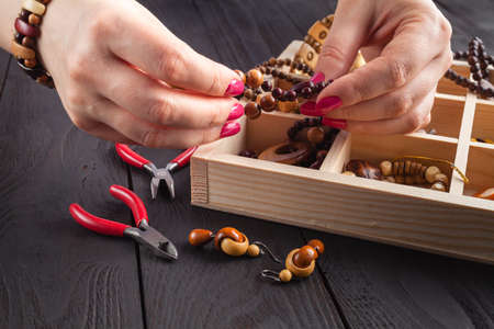 Handmade beading preparation on wooden table, DIY conceptの写真素材