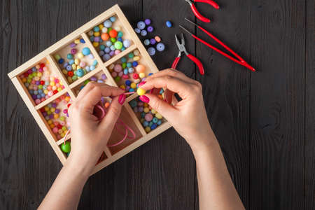 Handmade button bracelet. Set of bright colored buttons, pliers. DIY bangle jewelry idea. Easy make creative craftsの写真素材