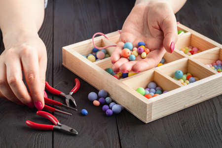 Woman making jewelry at homeの写真素材