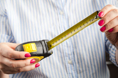 Penis Size Concept. Woman with Measuring Tapeの写真素材