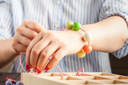 Woman making jewelry at homeの写真素材