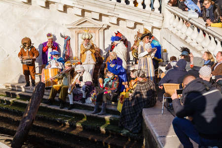 VENICE, ITALY â€“ FEBRUARY 17, 2019: People in carnival costumes on Piazza San Marco in Venice...
