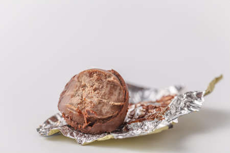 bitten chocolate candy in a candy wrapperの写真素材