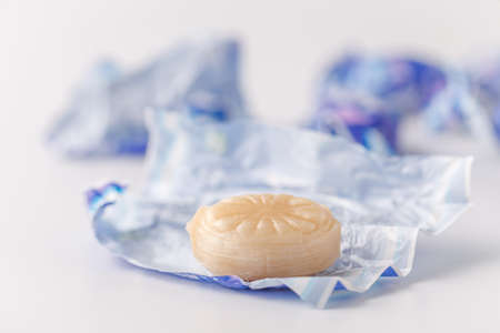 sweet caramel in round tin box on white backgroundの写真素材