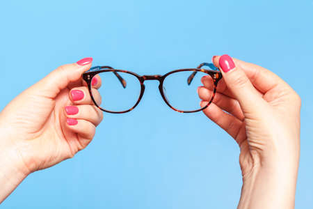 Ophthalmologist holding glasses for correction of visionの写真素材