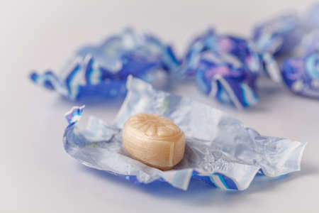 sweet caramel in round tin box on white backgroundの写真素材