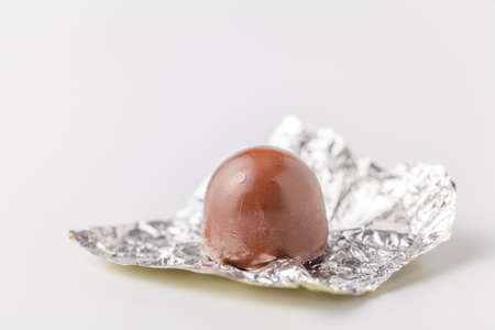 bitten chocolate candy in a candy wrapperの写真素材