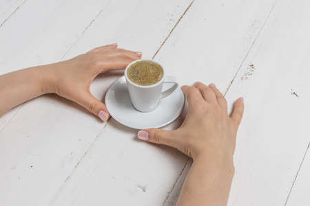Hand holding coffee cup on white backgroundの写真素材