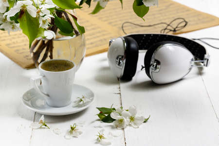Work space with a laptop, a cup of tea and flowers on the wooden background. Home office composition, freelance conceptの写真素材