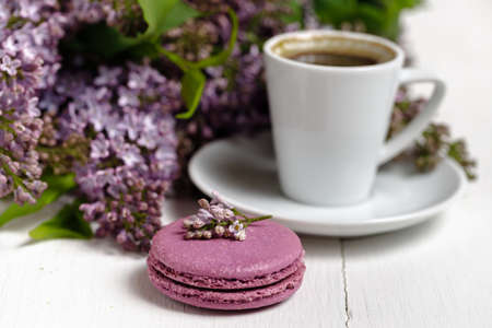 Coffee cup and colorful lilac flowers on garden tableの写真素材