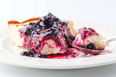 Cozy breakfast with a peace of berry cheesecakeの写真素材