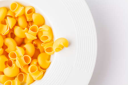 Raw elbow Macaroni (Gomiti Pasta) in bowlの写真素材