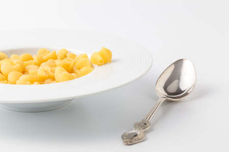 Italian pasta (Gomiti Rigati) on white backgroundの写真素材