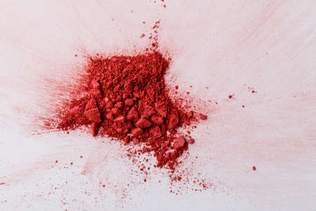 Makeup brush background with red blush sprinkled on white. Make up and female cosmetics backgroundの写真素材