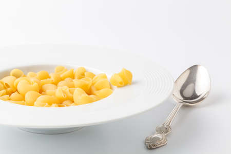 Dry Conchiglie pasta close up on whiteの写真素材