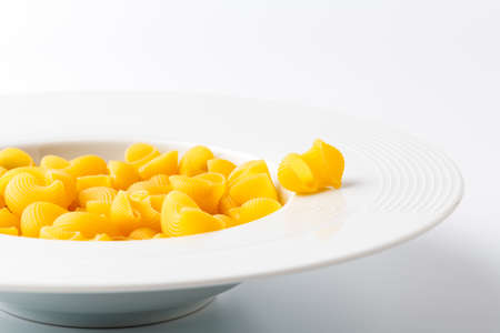 Raw elbow Macaroni (Gomiti Pasta) in bowlの写真素材
