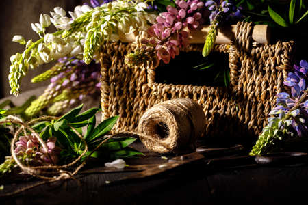 Fresh flowers, leaves, and tools to create a bouquet on a table, florist's workplaceの写真素材