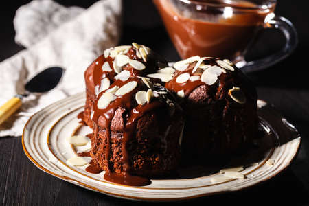 Chocolate muffins with nuts on dark background, selective focusの写真素材