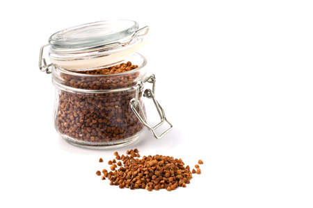bunch of buckwheat in jar, close up on a white background. Isolatedの写真素材
