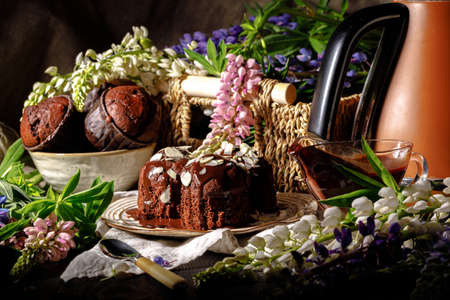 Chocolate muffins with chocolate syrup on dark background, selective focusの写真素材
