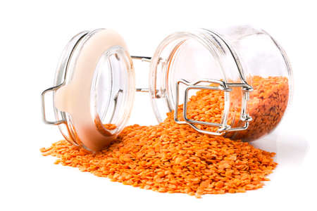 Red lentils in jar isolated on white backgroundの写真素材