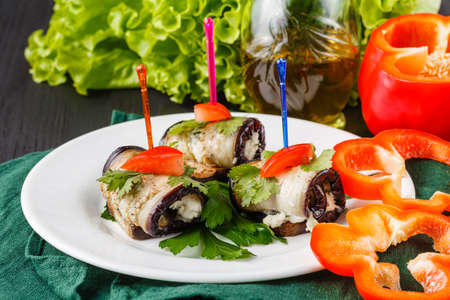 rolls of grilled slices of eggplant with feta cheese and tomato and Tzatziki sauce closeupの写真素材