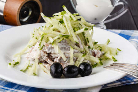 Fresh salad in wooden plate on wood tableの写真素材