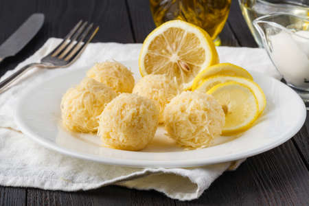 Small cheese balls on a plate. Cream cheese balls with dried herbs and roasted sesame seedsの写真素材