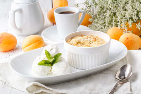 Crumble apricot pie on white table, morning dessertの写真素材