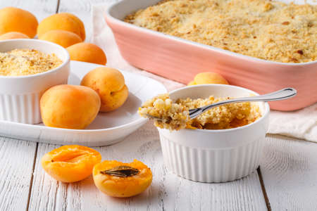 Crumble apricot pie on white table, morning dessertの写真素材