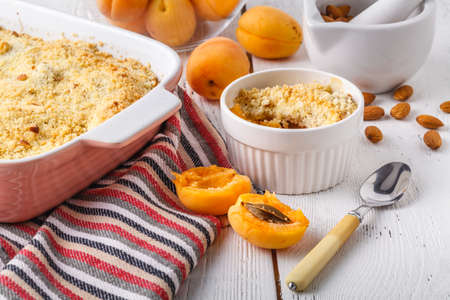 Crumble apricot pie on white table, morning dessertの写真素材