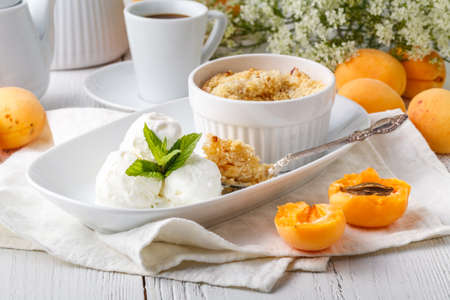 Freshly baked crumble with vanilla ice creamの写真素材