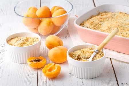 crumble with apricot and cinnamon served on tableの写真素材