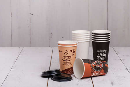 Paper cups of coffee on wooden texture backgroundの写真素材