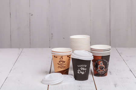 Paper cups of coffee on wooden texture backgroundの写真素材