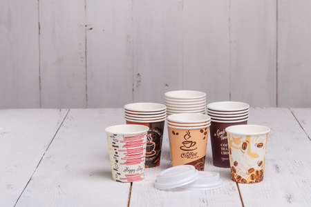 Disposable paper cups for coffee to go on wooden tableの写真素材