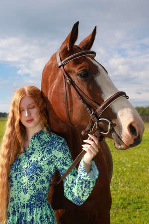 Woman with her horse at sunset, autumnの写真素材