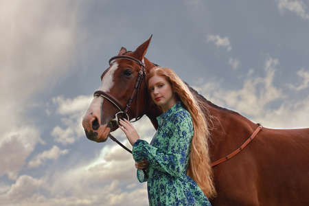 Pretty young girl together with her horsの写真素材