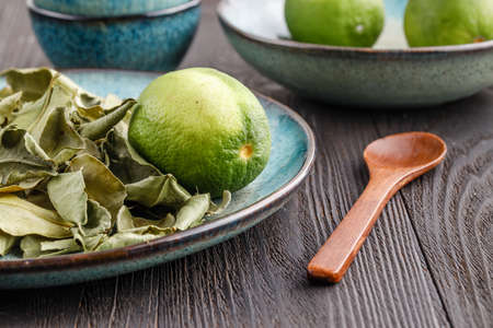 Fresh lime and dry leaf ready for cookingの写真素材
