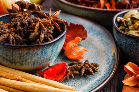 Apples, anis, cinnamon sticks and brown sugar on woodenの写真素材