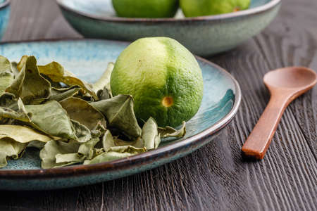 Fresh lime and dry leaf ready for cookingの写真素材