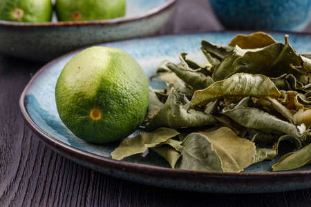 Fresh lime and dry leaf ready for cookingの写真素材
