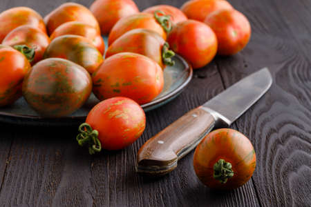 Fresh tomatoes and sauce on a rustic wooden backgroundの写真素材